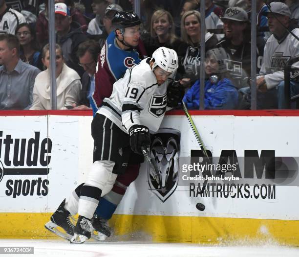 Colorado Avalanche defenseman Erik Johnson gets pinned along the boards by Los Angeles Kings center Alex Iafallo as they both go after the puck...