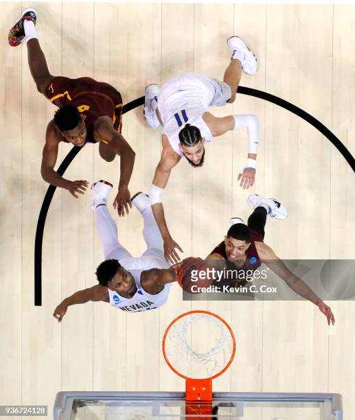 Jordan Caroline of the Nevada Wolf Pack and Lucas Williamson of the Loyola Ramblers battle for the rebound during the 2018 NCAA Men's Basketball...
