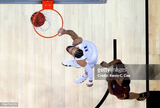 Cody Martin of the Nevada Wolf Pack dunks against Cameron Satterwhite of the Loyola Ramblers in the first half during the 2018 NCAA Men's Basketball...