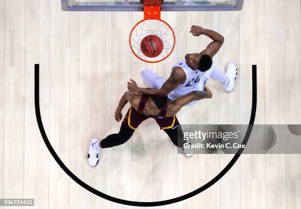Aundre Jackson of the Loyola Ramblers and Jordan Caroline of the Nevada Wolf Pack compete for a rebound in the first half during the 2018 NCAA Men's...