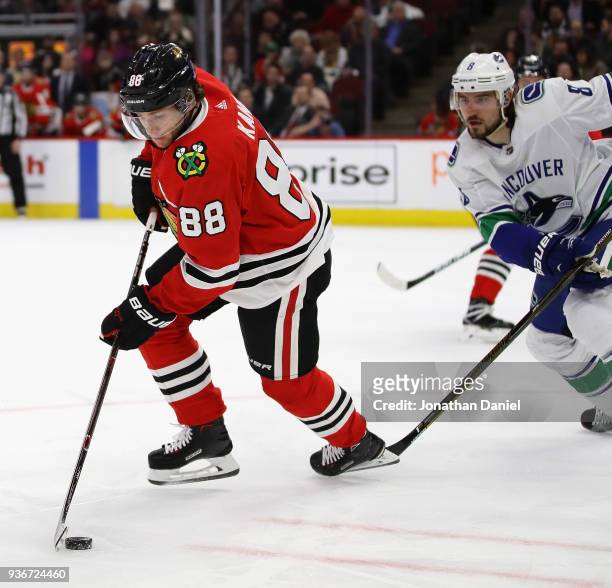 Patrick Kane of the Chicago Blackhawks does a 360 degree spin against Christopher Tanev of the Vancouver Canucks to get off a shot at the United...