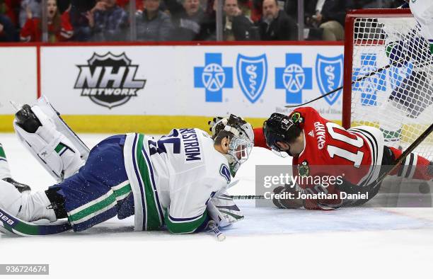 Patrick Sharp of the Chicago Blackhawks crashes into the net after Jacob Markstrom of the Vancouver Canucks made a save at the United Center on March...