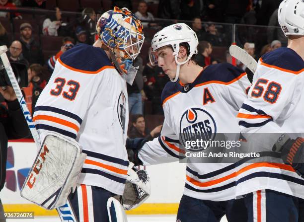 Cam Talbot and Ryan Nugent-Hopkins of the Edmonton Oilers celebrate their win against the Ottawa Senators at Canadian Tire Centre on March 22, 2018...