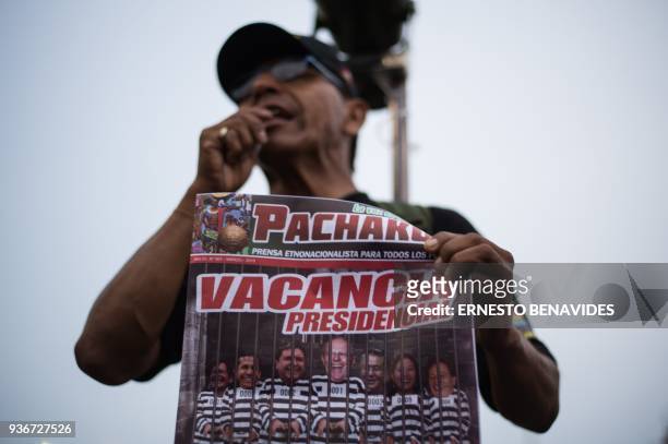 Man holds a magazine reading "Presidential vacancy" depicting Peruvian President Pedro Pablo Kuczyinski , Peruvian former presidents, Alan Garcia ,...