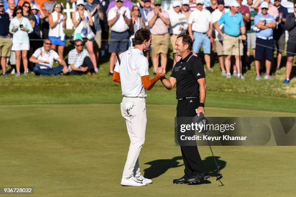 Sergio Garcia of Spain shakes hands with Dylan Frittelli of South Africa after his 2 up victory on the 18th hole green during round two of the World...