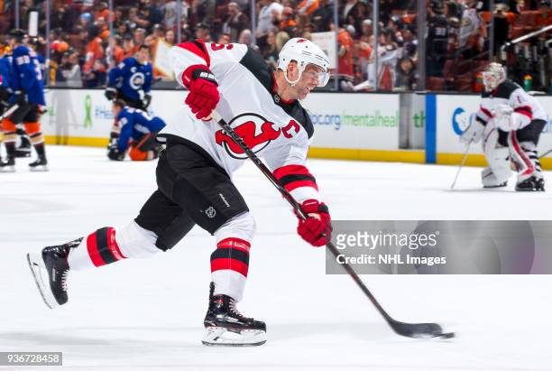 Andy Greene of the New Jersey Devils shoots during warm-up before the game against the Anaheim Ducks at Honda Center on March 18, 2018 in Anaheim,...