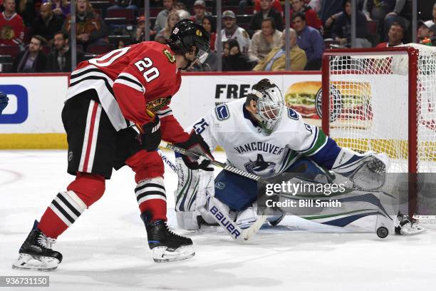 Goalie Jacob Markstrom of the Vancouver Canucks blocks the shot by Brandon Saad of the Chicago Blackhawks in the third period at the United Center on...