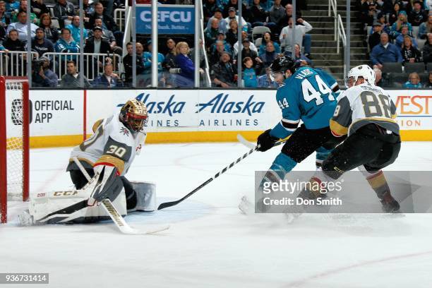 Malcolm Subban of the Vegas Golden Knights makes a save as Marc-Edouard Vlasic of the San Jose Sharks looks for the rebound while being defended by...
