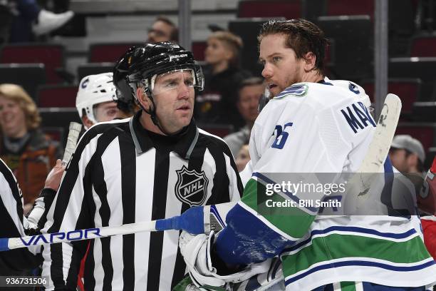 Goalie Jacob Markstrom of the Vancouver Canucks talks with linesman Michel Cormier in the third period against the Chicago Blackhawks at the United...