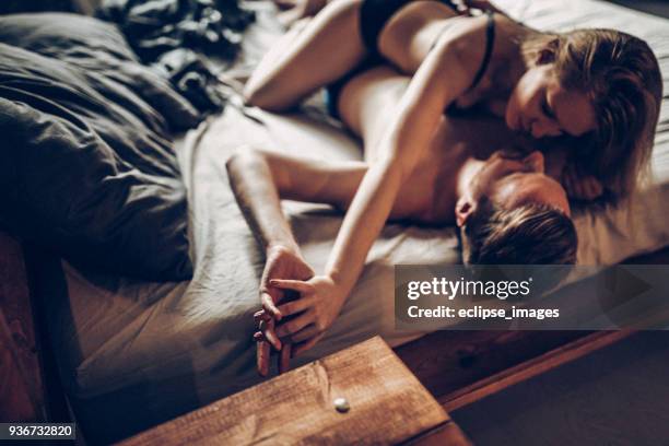 you are mine... - man and woman kissing in bed stock pictures, royalty-free photos & images