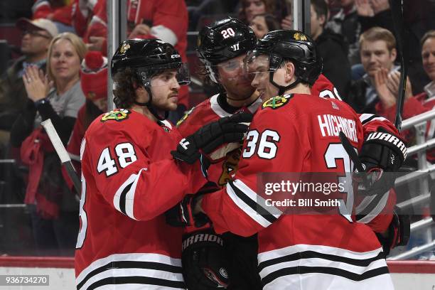 Matthew Highmore of the Chicago Blackhawks celebrates with Vinnie Hinostroza and Brandon Saad after scoring against the Vancouver Canucks in the...