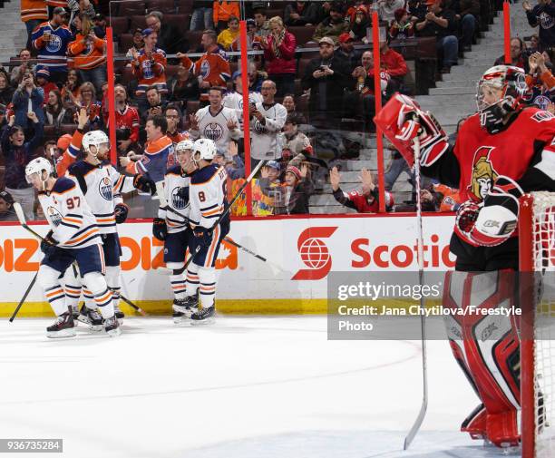 Connor McDavid of the Edmonton Oilers celebrates his third period goal and fourth point on the night against the Ottawa Senators with teammates Ty...