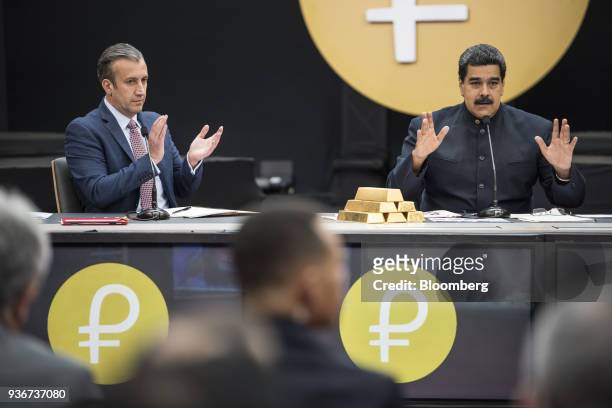Nicolas Maduro, Venezuela's president, speaks next to a stack of 12 Kilogram gold ingots as Tareck El Aissami, Venezuela's vice president, left,...