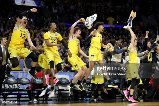 The Michigan Wolverines bench celebrates in the games final minutes against the Texas A&M Aggies in the 2018 NCAA Men's Basketball Tournament West...