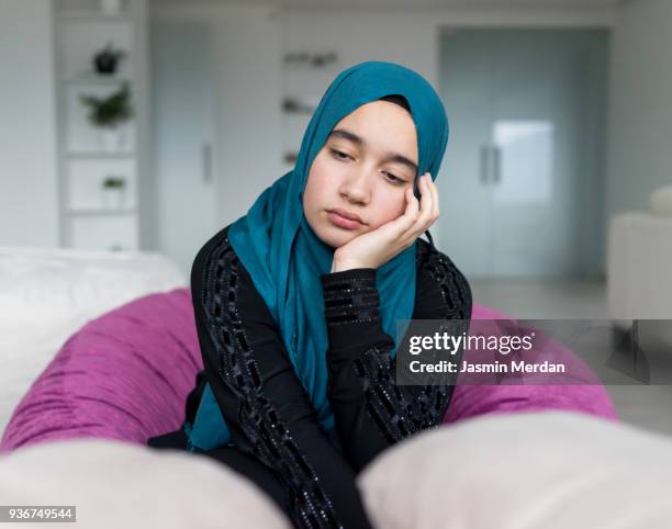 sad muslim girl - hijab girl ストックフォトと画像