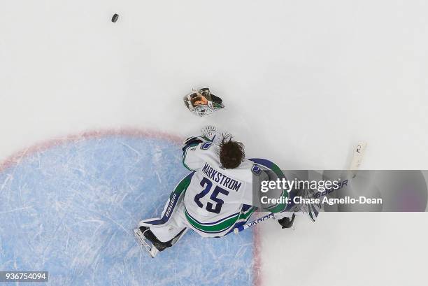 Goalie Jacob Markstrom of the Vancouver Canucks loses his helmet in the third period against the Chicago Blackhawks at the United Center on March 22,...