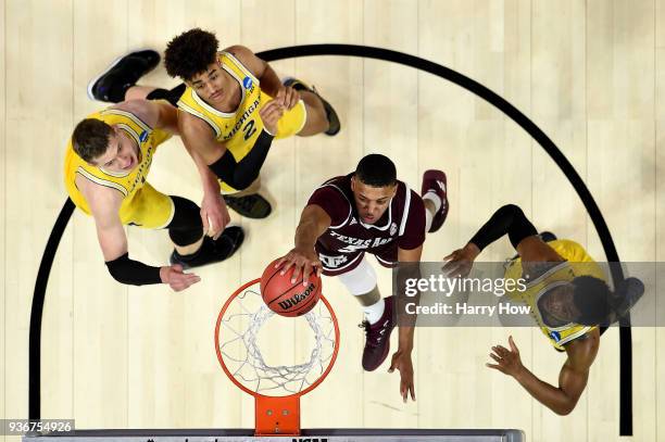 Savion Flagg of the Texas A&M Aggies dunks the ball against the Michigan Wolverines in the 2018 NCAA Men's Basketball Tournament West Regional at...