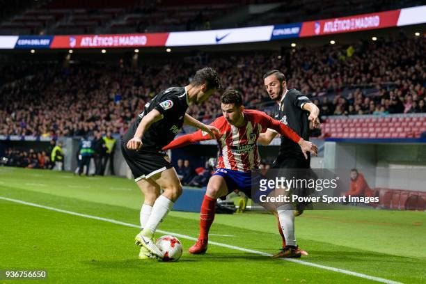 Lucas Hernandez of Atletico de Madrid fights for the ball with Sebastien Corchia of Sevilla FC and Pablo Sarabia Garcia of Sevilla FC during the Copa...
