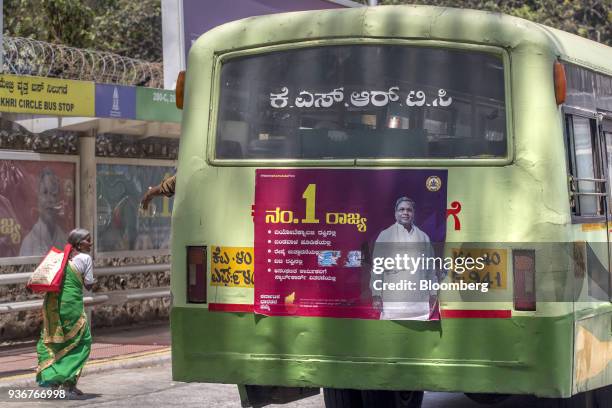 Bus travelling along a road displays an image of Karnataka Chief Minister K. Siddharamaiah, of the Indian National Congress party , in Bengaluru,...