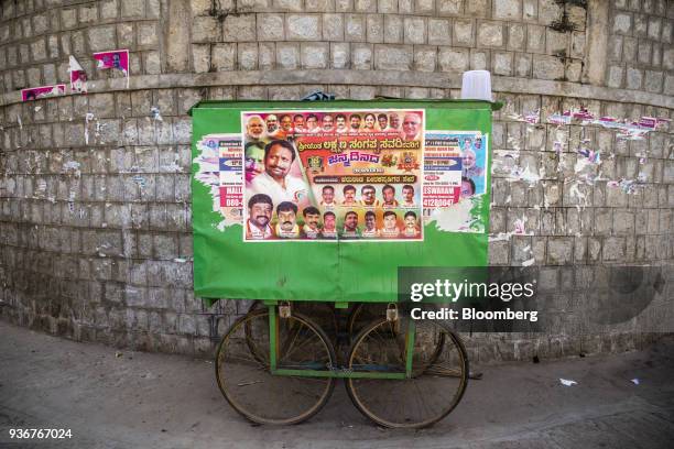 Political party posters endorsing cultural events are displayed on a cart in Bengaluru, Karnataka, India, on Wednesday, March 14, 2018. Prime...