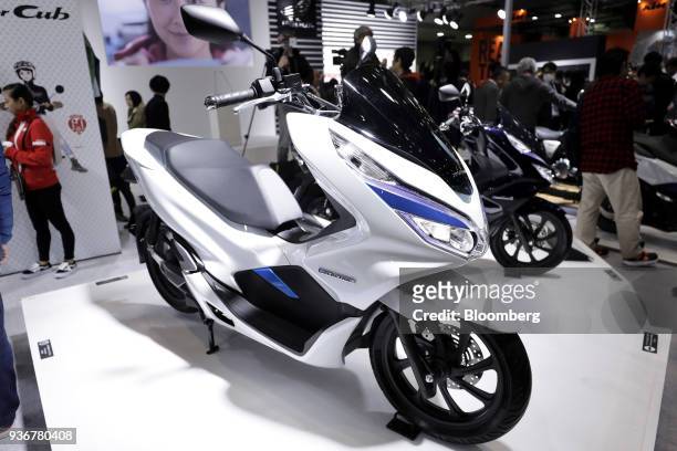 Honda Motor Co. PCX Electric scooter stands on display at the Tokyo Motorcycle Show in Tokyo, Japan, on Friday, March 23, 2018. The show runs until...