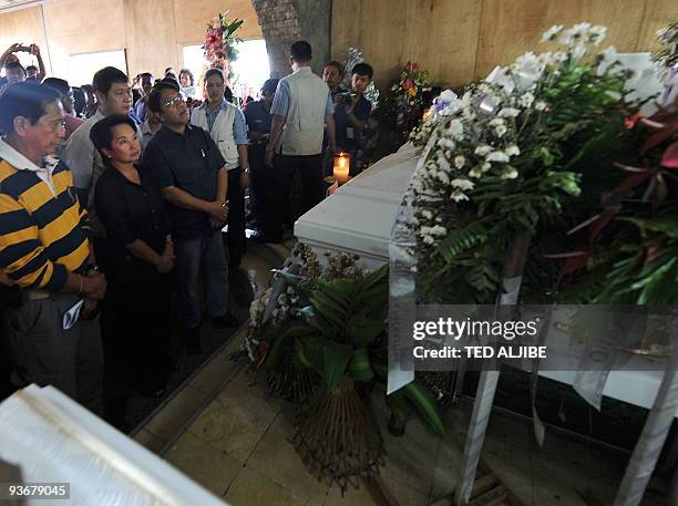 Philippine President Gloria Arroyo views the coffins of slain journalists at the wake in General Santos City, south Cotabato province on December 3,...