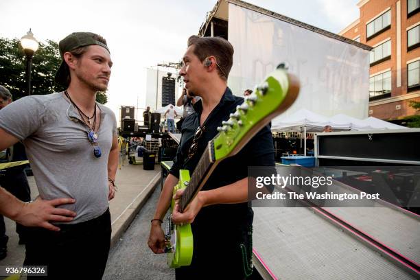Taylor and Issac Hanson talk backstage about a guitar they had had made to raffle for the Community Food Bank of Eastern Oklahoma at Hop Jam in...