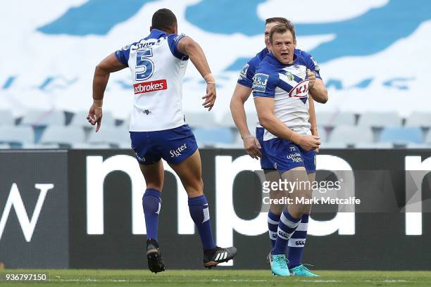 Josh Morris of the Bulldogs celebrates scoring a try during the round three NRL match between the Bulldogs and the Panthers at ANZ Stadium on March...