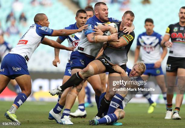 Trent Merrin of the Panthers is tackled during the round three NRL match between the Bulldogs and the Panthers at ANZ Stadium on March 23, 2018 in...