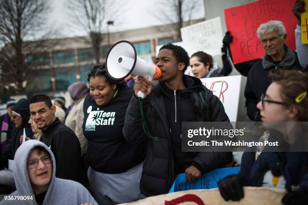 Boston high school student Fred-Jerome Johnson leads a chant during a protest in front of Smith & Wesson's headquarters in Springfield, Massachusetts...