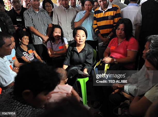 Philippine President Gloria Arroyo holds a dialogue with relatives of slain journalists during a visit at the wake in General Santos City, south...