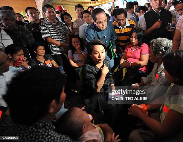 Philippine President Gloria Arroyo holds a dialogue with releatives of slain journalists during a visit at the wake in General Santos City, south...