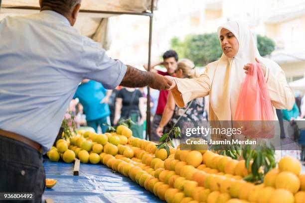 muslim woman on bazaar - antalya city stock-fotos und bilder