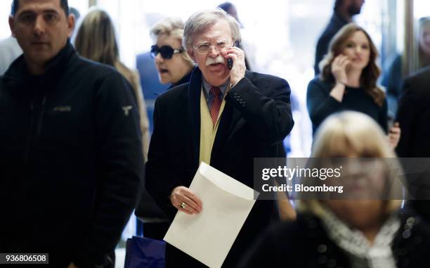 John Bolton, former U.S. Ambassador to the United Nations , talks on a mobile device while walking through the lobby at Trump Tower in New York,...