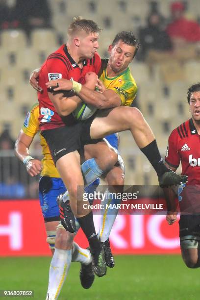 Bulls' Handre Pollard competes for the ball with Crusaders' Jack Goodhue during the Super Rugby union match between the Canterbury Crusaders of New...