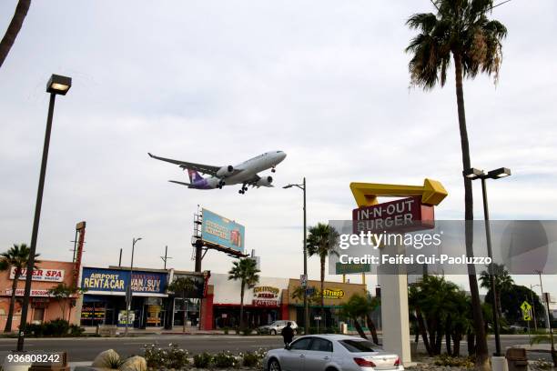an airplane flying through street of westchester, los angeles airport, california, usa - westchester ca stock pictures, royalty-free photos & images