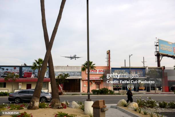 an airplane flying through street of westchester, los angeles airport, california, usa - westchester ca stock pictures, royalty-free photos & images