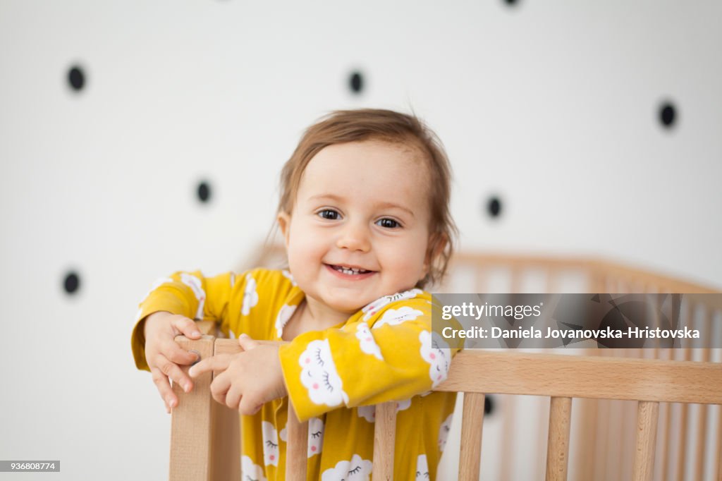 Cute baby girl in baby crib