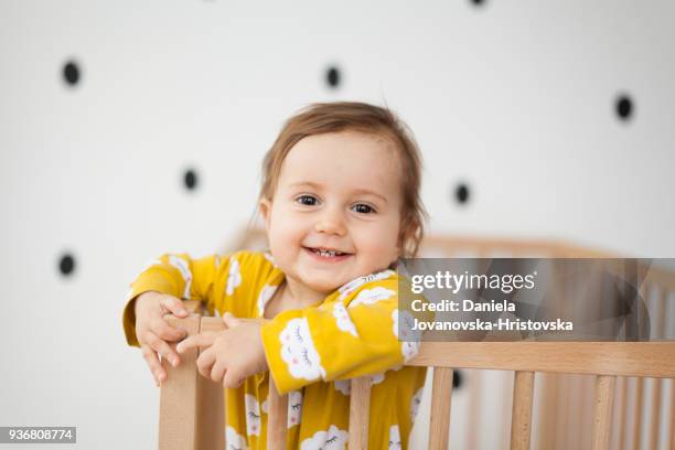 cute baby girl in baby crib - baby crib stock pictures, royalty-free photos & images