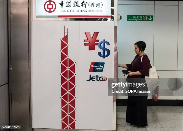 Woman withdraws money from an Bank of China ATM in MTR subway. Hong Kong is a city with 7.5 million population in 2017, it was a British Crown colony...