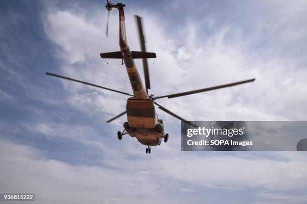 An Mi-17 transport helicopter of the Afghan Air Force approaches for landing on the main road in the desert of Bolo Bluk district, Farah province,...