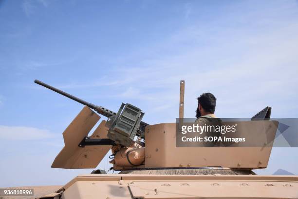 An Afghan Commando in the turret of his HMMWV, equipped with a M2 Browning heavy machine gun, somewhere on the main road in Bolo Bluk district, Farah...