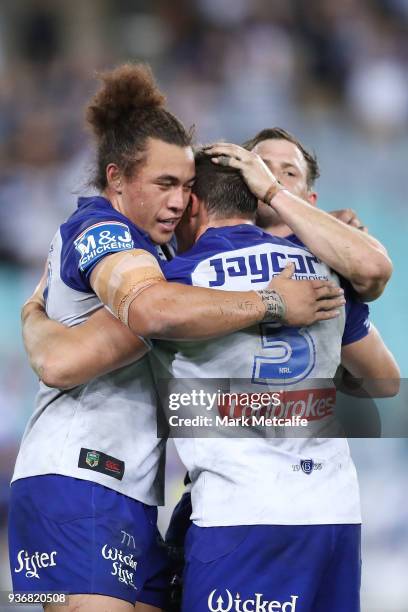 Josh Morris, Brett Morris and Raymond Faitala-Mariner of the Bulldogs celebrate victory in the round three NRL match between the Bulldogs and the...