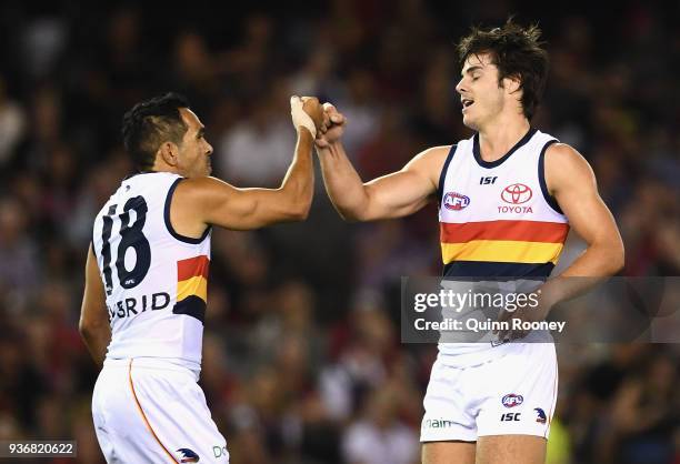 Darcy Fogarty of the Crows is congratulated by Eddie Betts after kicking a goal during the round one AFL match between the Essendon Bombers and the...