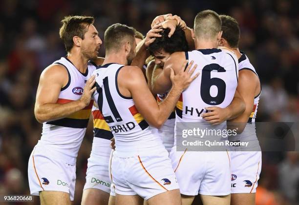 Darcy Fogarty of the Crows is congratulated by team mates after kicking a goal during the round one AFL match between the Essendon Bombers and the...