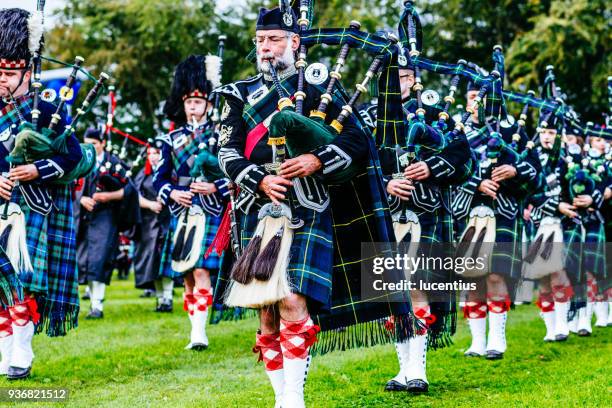 marching scottish pipe band - bagpipes stock pictures, royalty-free photos & images