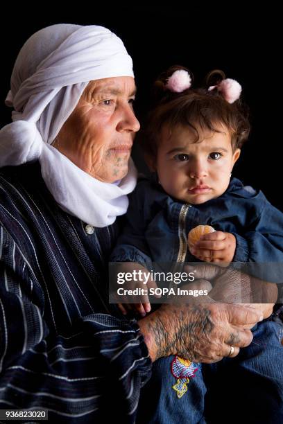 Mayre Hame, 65 or 66 year-old woman from Bir Rame, a village of Kobani, Syria, with her one year old granddaughter Lina, photographed at a refugee...