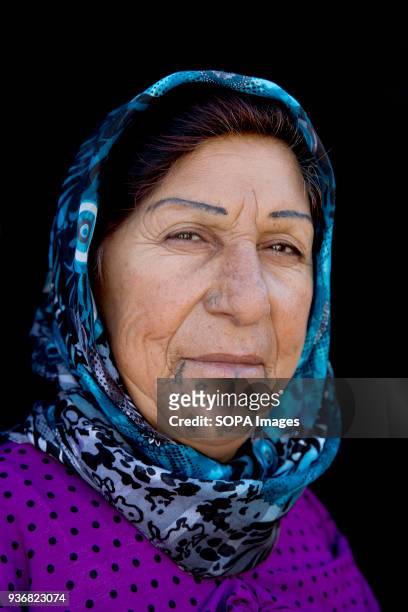 Noyle Muzlem, 55 from El Ajak village of Kobani, Syria photographed at refugee camp in Turkey. "It's an old tradition. I don't really like my...