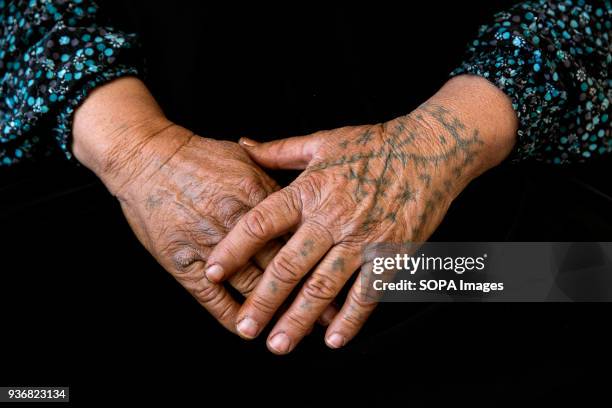 Tattooed hands of Zubeyda Ali who fled Kobani, Syria, with her whole family, including ten married children and 25 grandchildren. She was tattooed at...