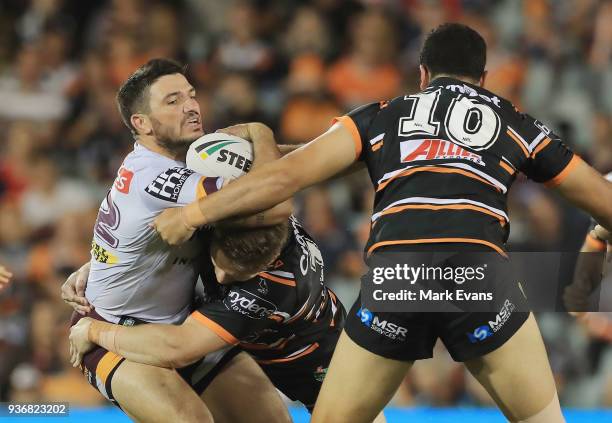 Matt Gillett of the Broncos is tackled the round three NRL match between the Wests Tigers and the Brisbane Broncos at Campbelltown Sports Stadium on...